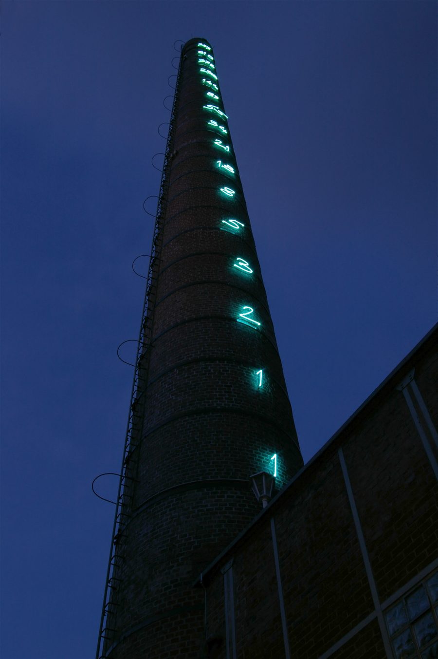 Fibonacci numbers illuminated at night on the chimney of the former Linden Brewery in Unna