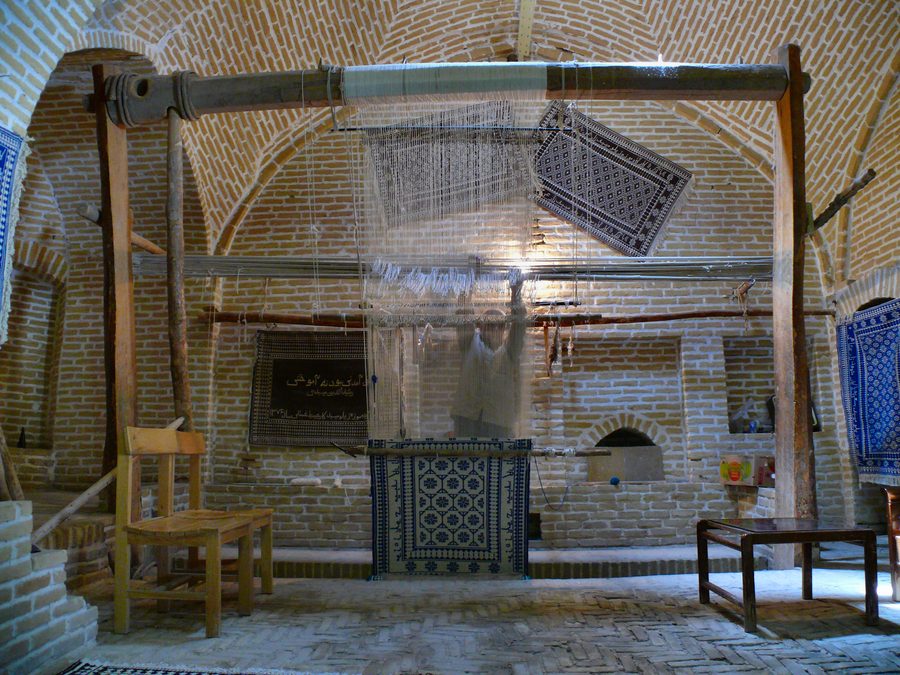A carpet weaver in a restored caravanserai