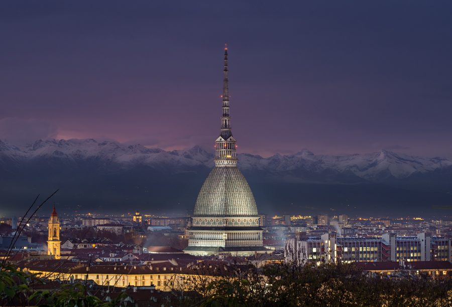 Mole Antonelliana in Turin at night with the Alps in the background
