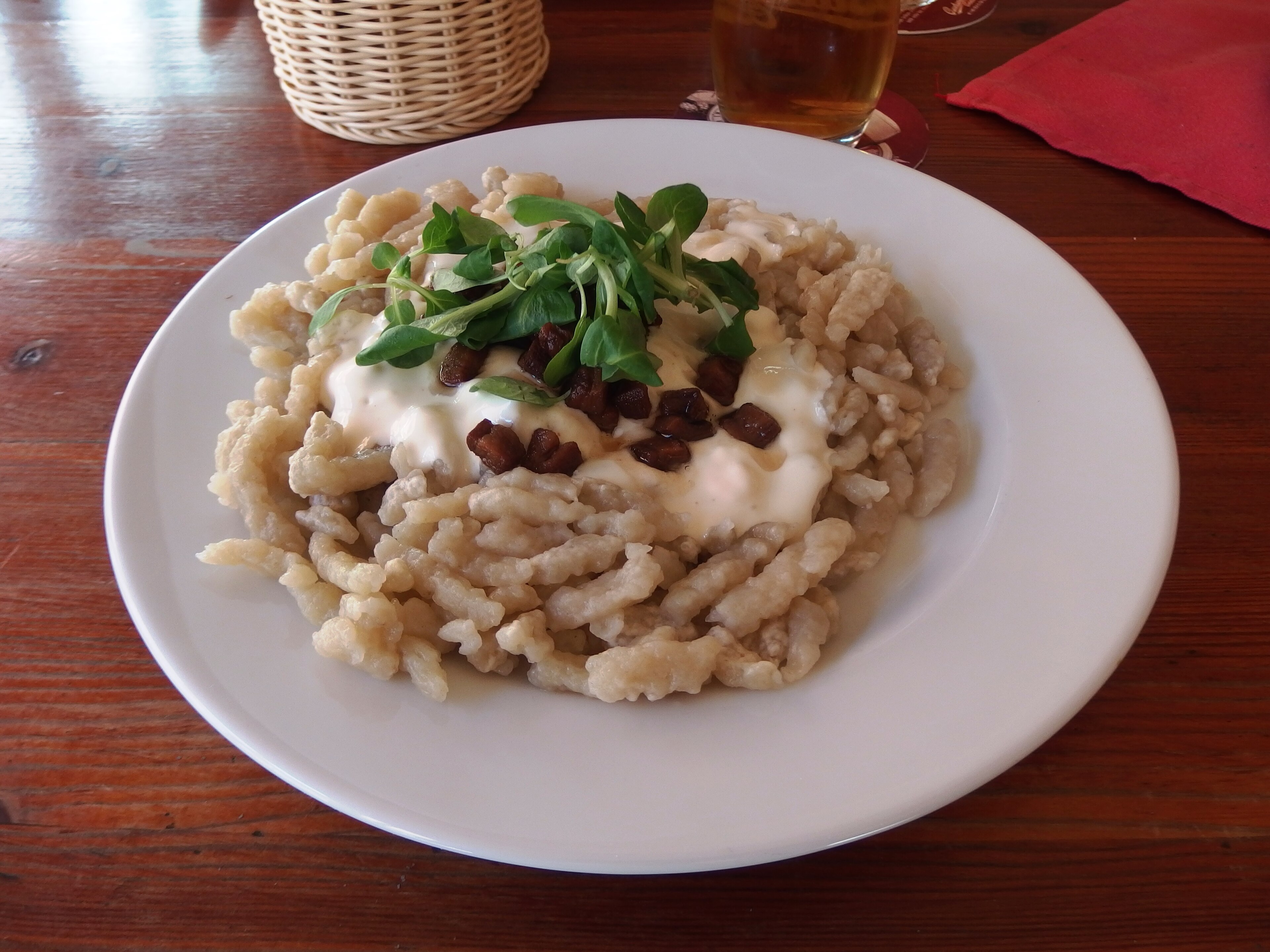 Serving of Bryndzové halušky, potato dumplings with sheep cheese and bacon