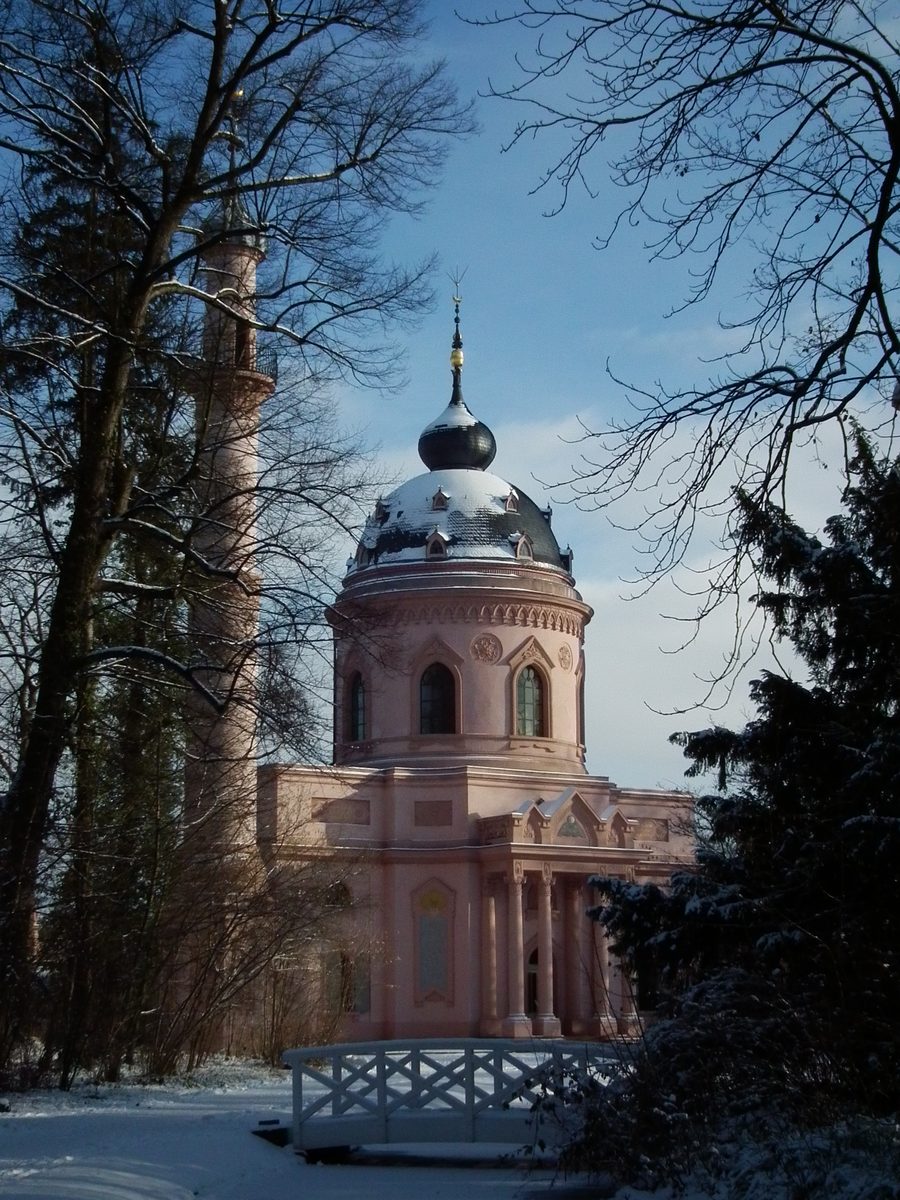 The Red Mosque in Schwetzingen Palace Gardens among trees and landscaped grounds.