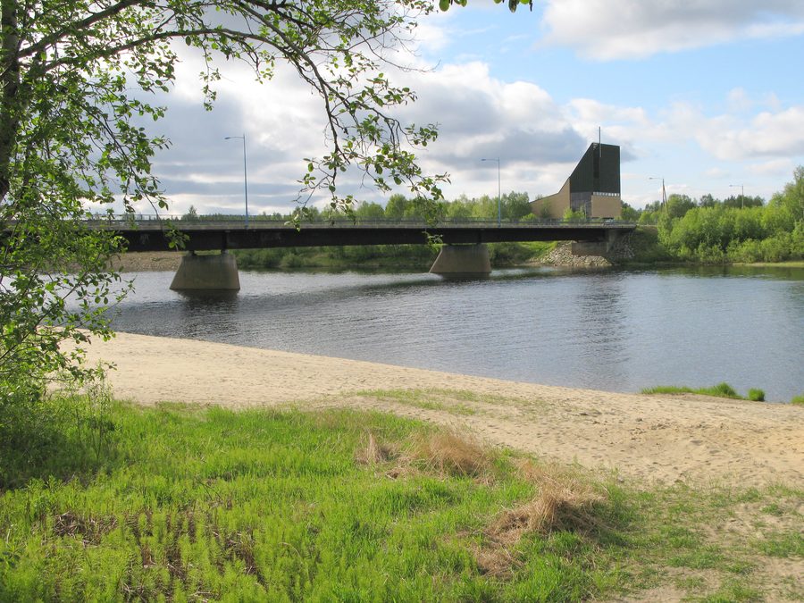 Ivalojoki with road bridge and church in Finnish Lapland