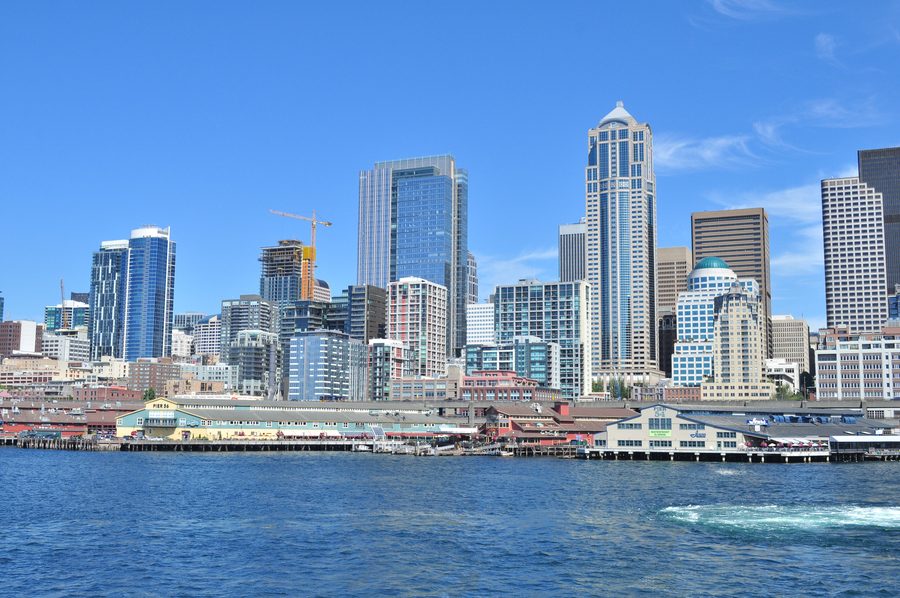 Downtown Seattle skyline seen from Elliott Bay with water in the foreground.