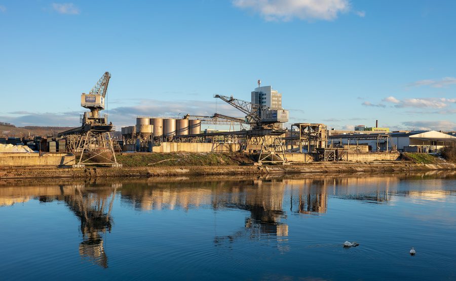 View of the canalized Neckar and harbor cranes in Heilbronn on a winter evening