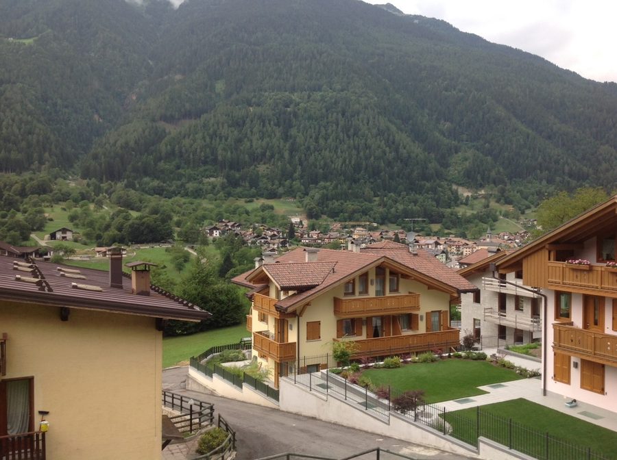 Panoramic view of Bocenago seen from the balcony of an apartment, with the mountains of Val Rendena in the background.