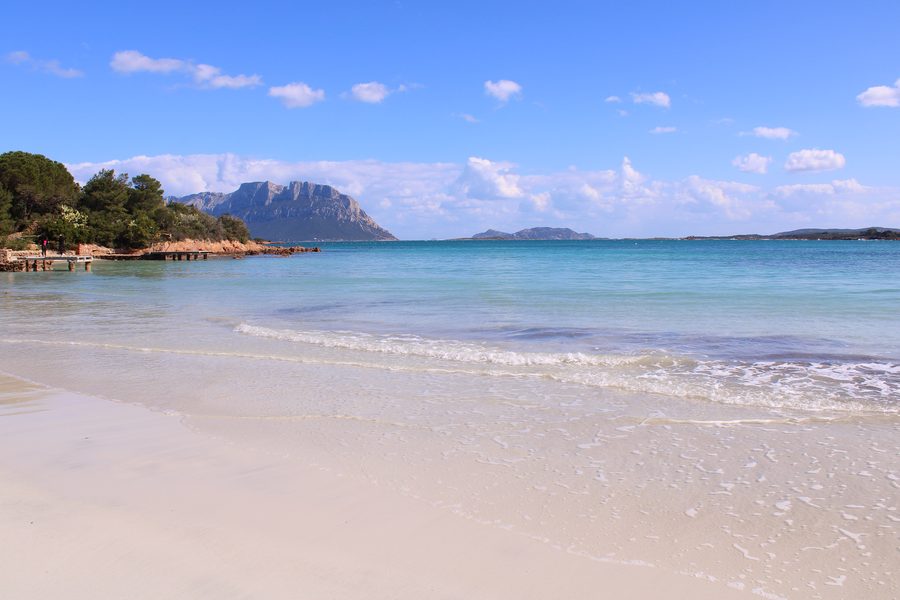 Beach of Porto Istana with light sand and view of Tavolara