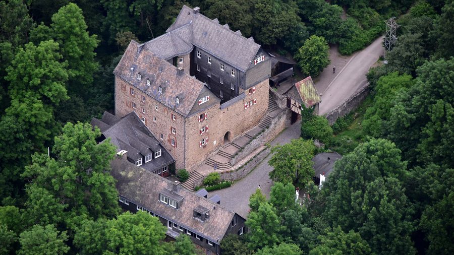 Aerial view of Hessenstein Castle on a wooded hill near Ederbringhausen in Vöhl