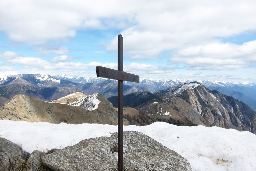 Summit cross on Monte Ziccher above Val Vigezzo, with Punta della Forcoletta and Pizzo Ruscada in the background