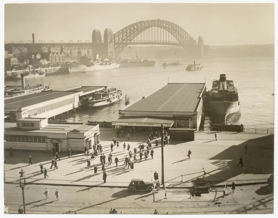 Passengers disembark from the Manly ferry at Circular Quay in front of the Harbour Bridge