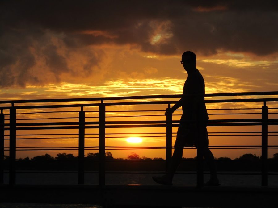 Person on the GuaÃba waterfront in Porto Alegre at sunset