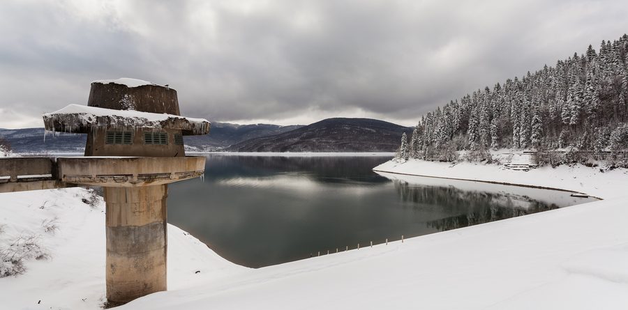Winter landscape at Mavrovo Lake with dam and observation tower