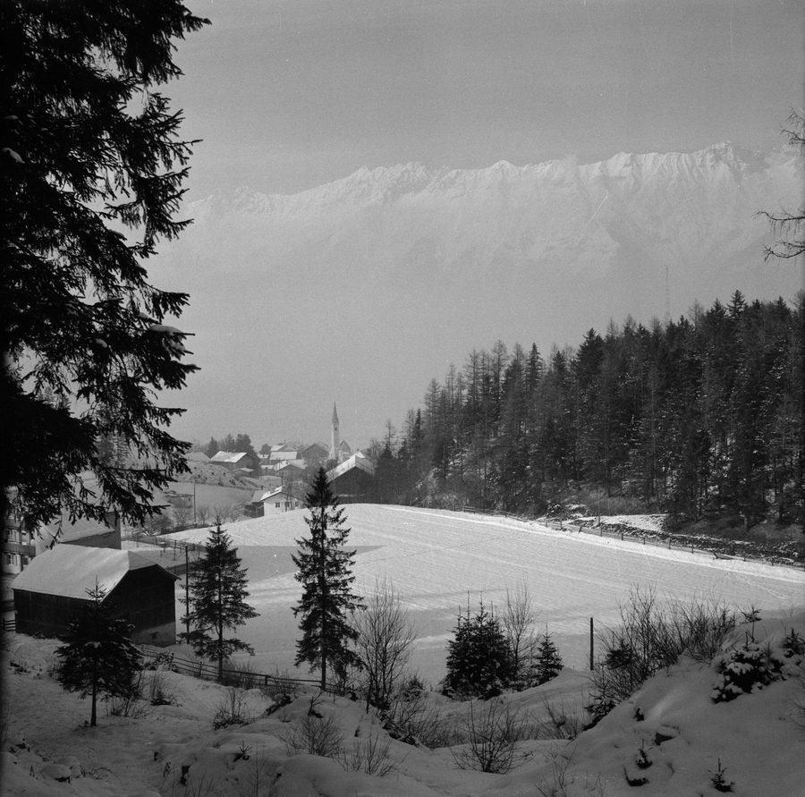 Aldrans in Tyrol as a snow-covered village before an alpine mountain landscape