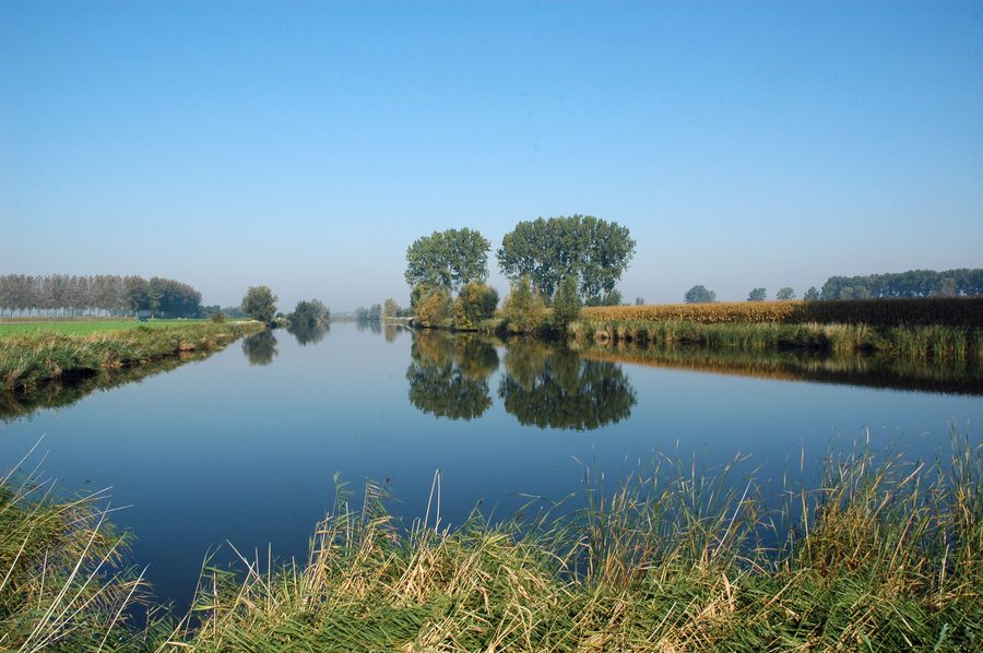 View of the Hollandersgatkreek in Sint-Laureins with flat polder landscape