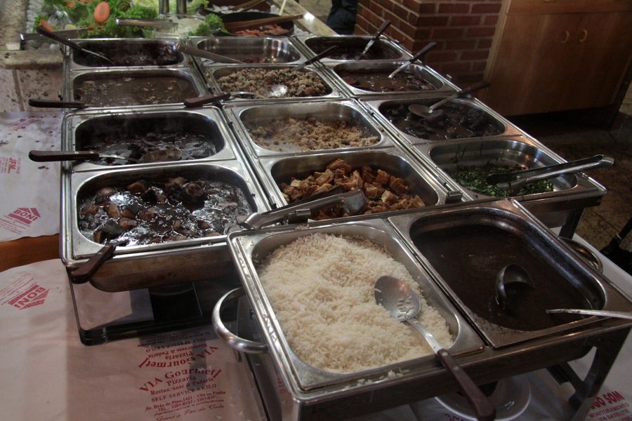 A plate of feijoada served in a restaurant.
