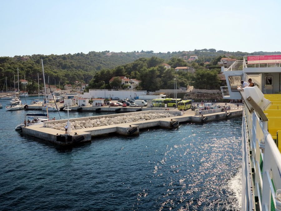 Rogač on Šolta with a ferry pier and yellow buses at the harbor
