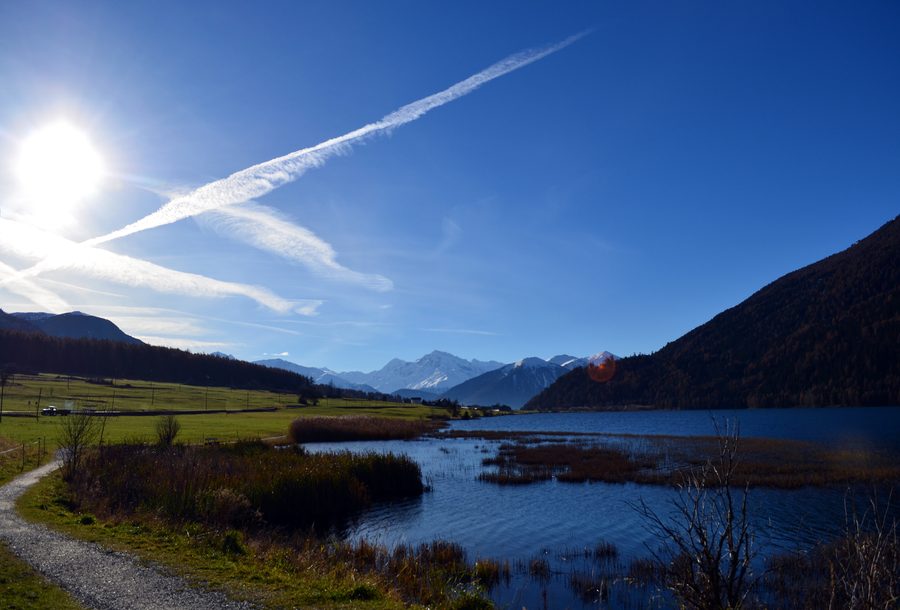 Reschensee surrounded by snow-covered Alpine mountains in South Tyrol