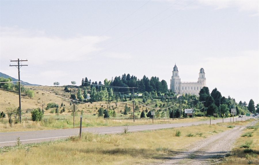 Manti Temple in Utah from a distance with mountain scenery in the background