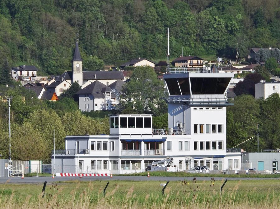 View of the control tower of Chambéry-Savoie Airport and the church of Voglans