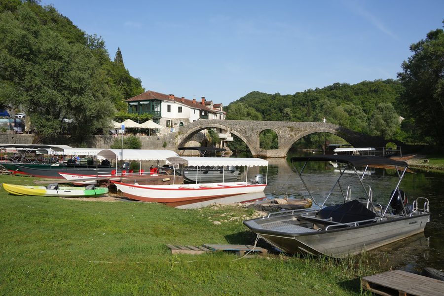 Historic stone arch and quay on the river in Rijeka Crnojevića