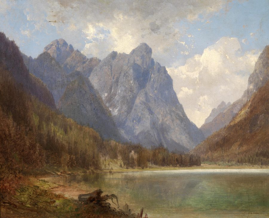 Lake Toblach in the Puster Valley in front of an alpine mountain backdrop