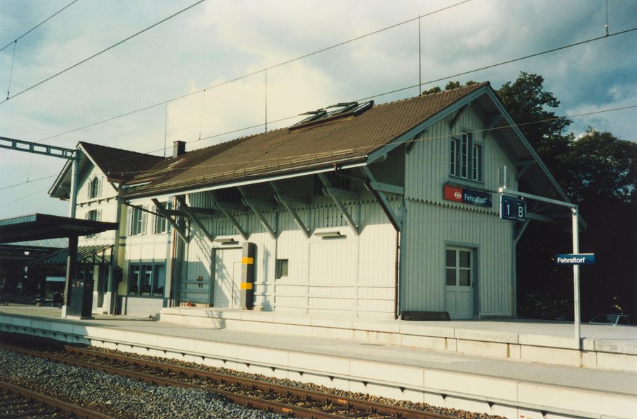 Historic station building of Fehraltorf with goods shed on the railway side
