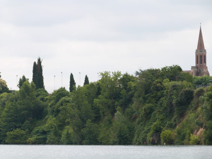 Bell tower of Saint-Martin church in Terssac seen from a gabarre on the Tarn
