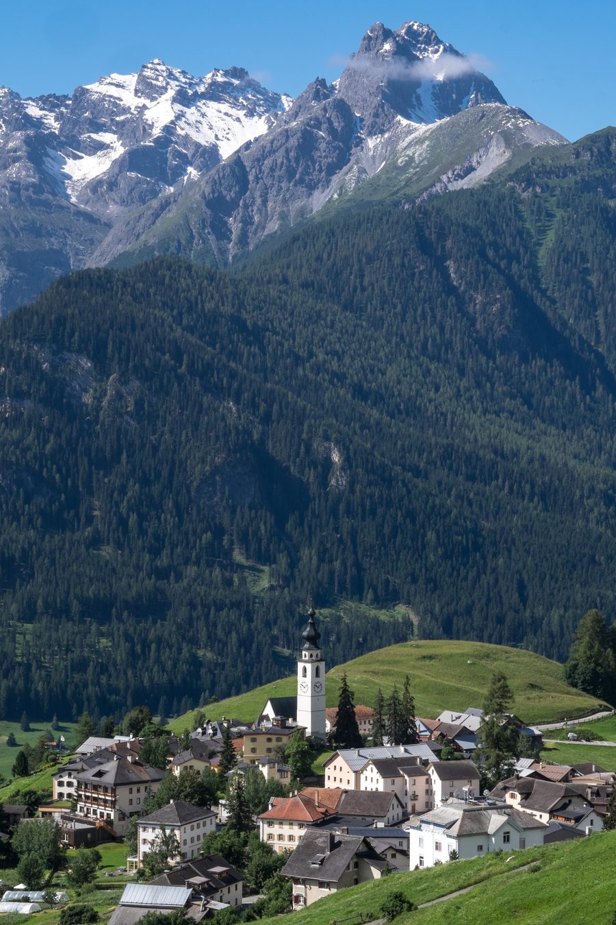 Ftan with village houses, church, and mountain panorama in the Lower Engadine